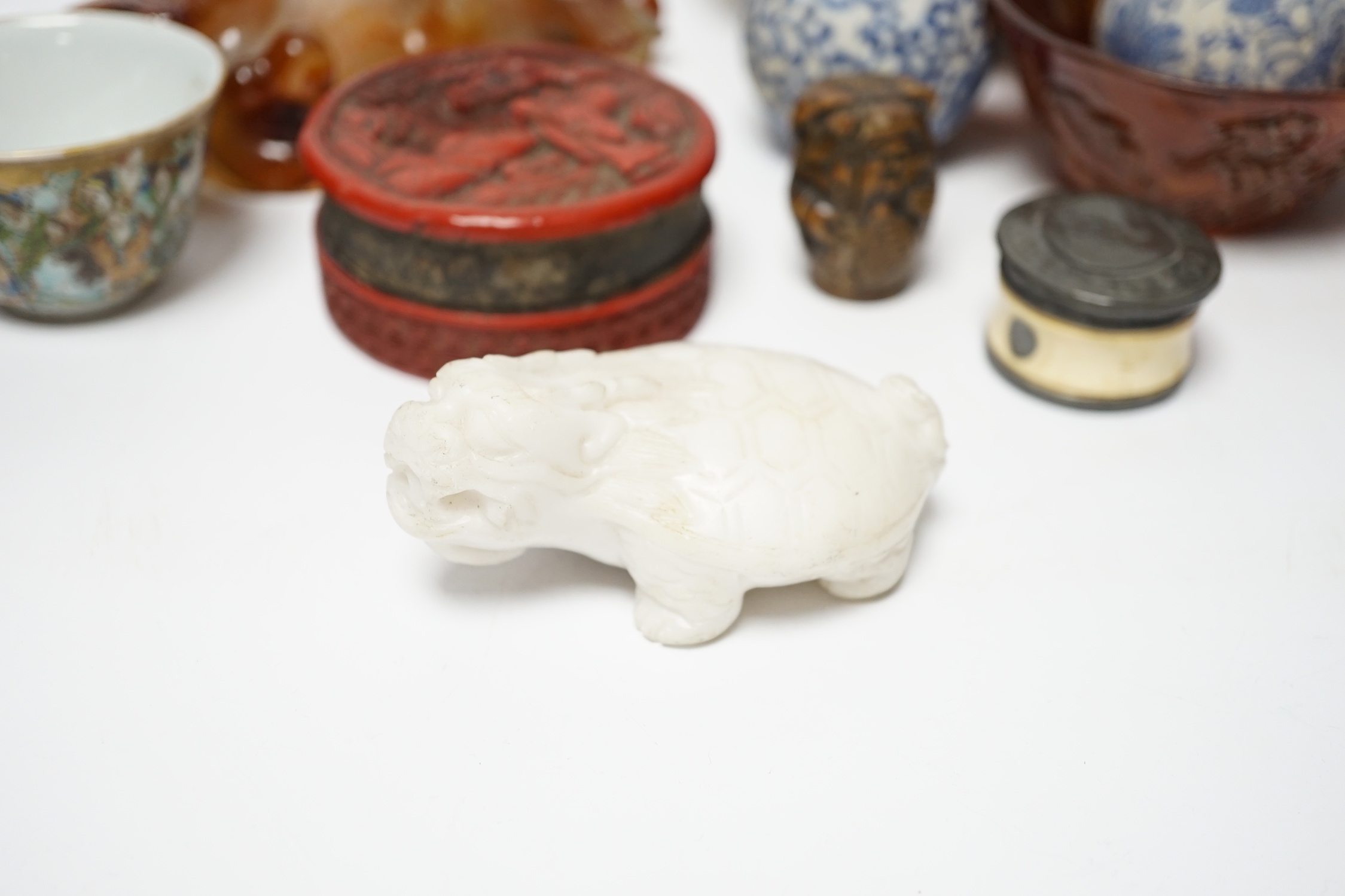 Eleven Chinese or Japanese items including; a bowl, a red lacquer box, an agate carving of a bird group, a carved hardstone lion tortoise, mother of pearl counters, etc.